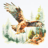 Kit de punto de cruz Magic Needle 70-48 Above the World con águila volando sobre un paisaje de bosque y pinos, bordado en Aida Zweigart blanco antiguo.