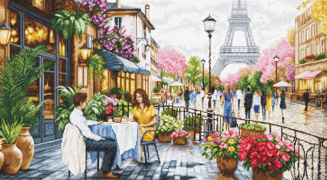 Kit de punto de cruz Luca-S GOLD BU5108 Tower View con cafetería parisina, terraza con flores y vista a la Torre Eiffel al fondo.