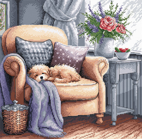 Kit de punto de cruz AVA Stitch P053 Sweet Dreams con perro pequeño dormido en un sofá beige, manta, cojines y flores en una escena acogedora de interior.