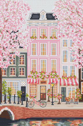 Casas típicas de Ámsterdam junto al canal con bicicleta y flores en punto de cruz