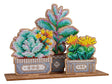 Decoración bordada con abalorios sobre base de madera en forma de jardín de suculentas en 3D con colores verdes y detalles florales