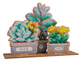 Decoración bordada con abalorios sobre base de madera en forma de jardín de suculentas en 3D con colores verdes y detalles florales